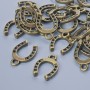 Pendant Finding "Horseshoe", diameter 15×11mm, hole diameter 1.9mm, packaging 24 pcs±, bronze metal color