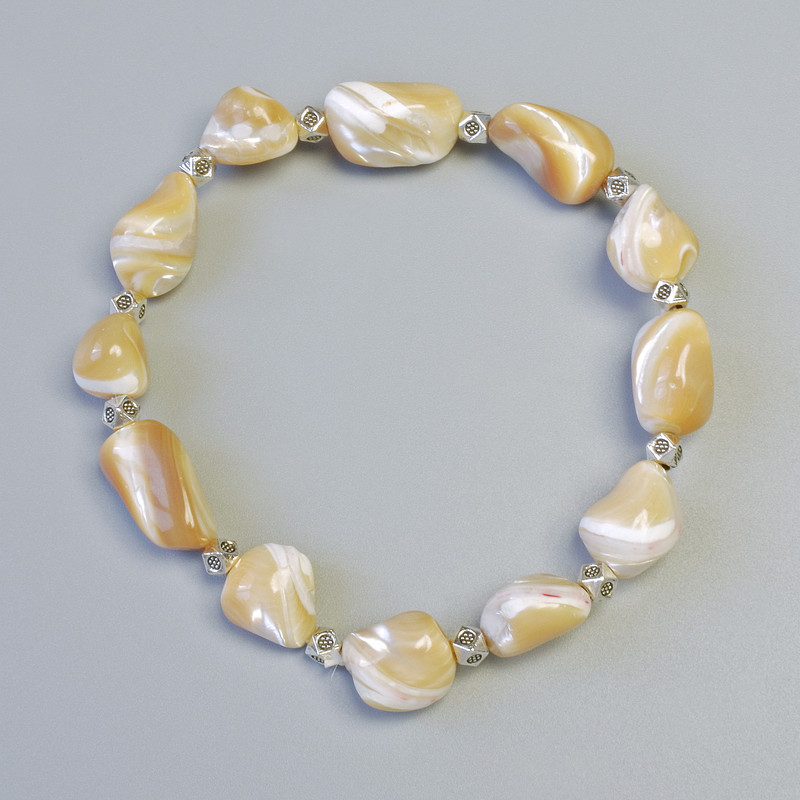 Bracelet Beige Mother-of-P Pearl, faceted beads 10x13mm± (stretch), length 18cm± with metal inserts
