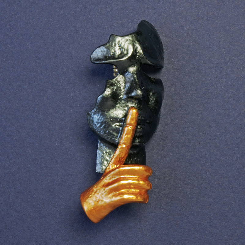 Brooch Mask in dark gray and yellow enamel with golden metal color 52x20mm