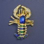 Brooch Omar blue and green enamel with golden metal 58x43mm