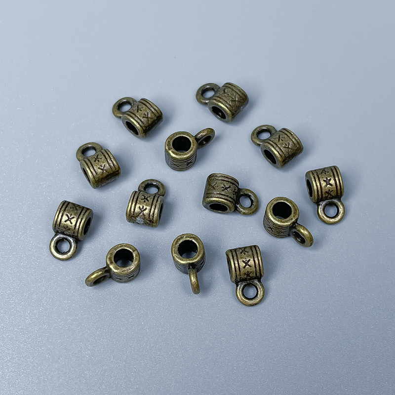 Bead bail color bronze, size 9x5x5 mm ±, holes diameter ~2.5 mm ±, diameter ~2 mm ±, packaging 34 pcs