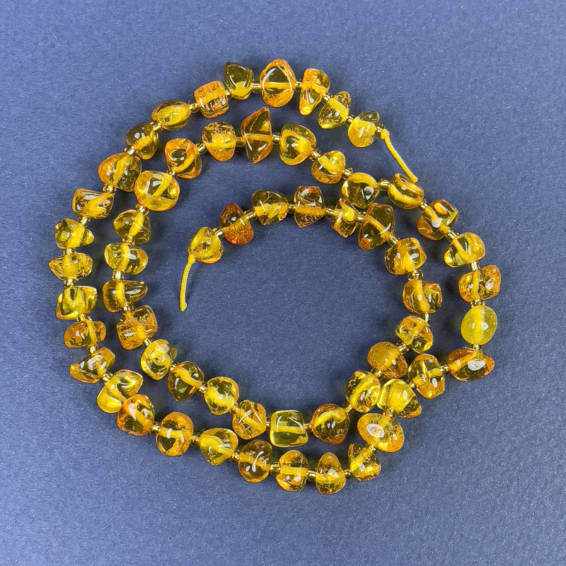 Amber Beads Cabochon-cut 6x4 mm on a Thread with 2 mm Beads ±, length 39 cm+