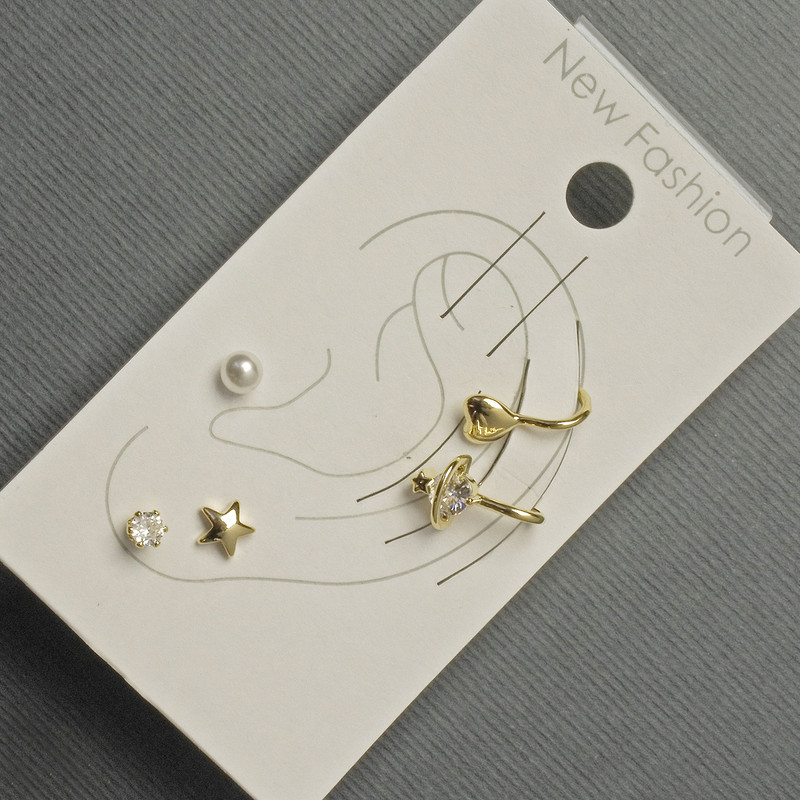 Earrings - studs and clips on the earlobe with golden metal, white rhinestones and a pearl