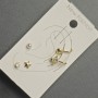 Earrings - studs and clips on the earlobe with golden metal, white rhinestones and a pearl