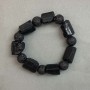 Bracelet Tourmaline Schorl unpolished natural stone rough pieces, diameter 19–27×15 mm +- Lava bead 12 mm +- length 22–23 cm +- stretch