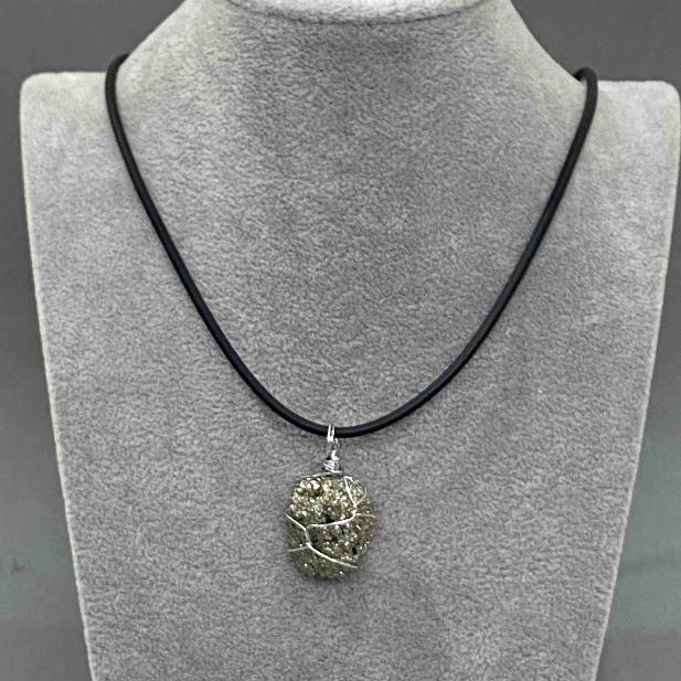 Pyrite Pendant Unpolished in Weaving, diameter assortment 25×12×37-20×15×30mm± on cord, length 50cm±5cm± chain