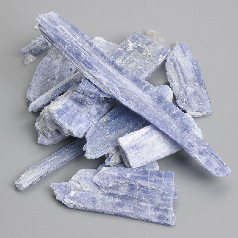 Souvenir stone for interior, unpolished kyanite 18-80x6-25 mm ± packaged 100 g (Price per 100 g)
