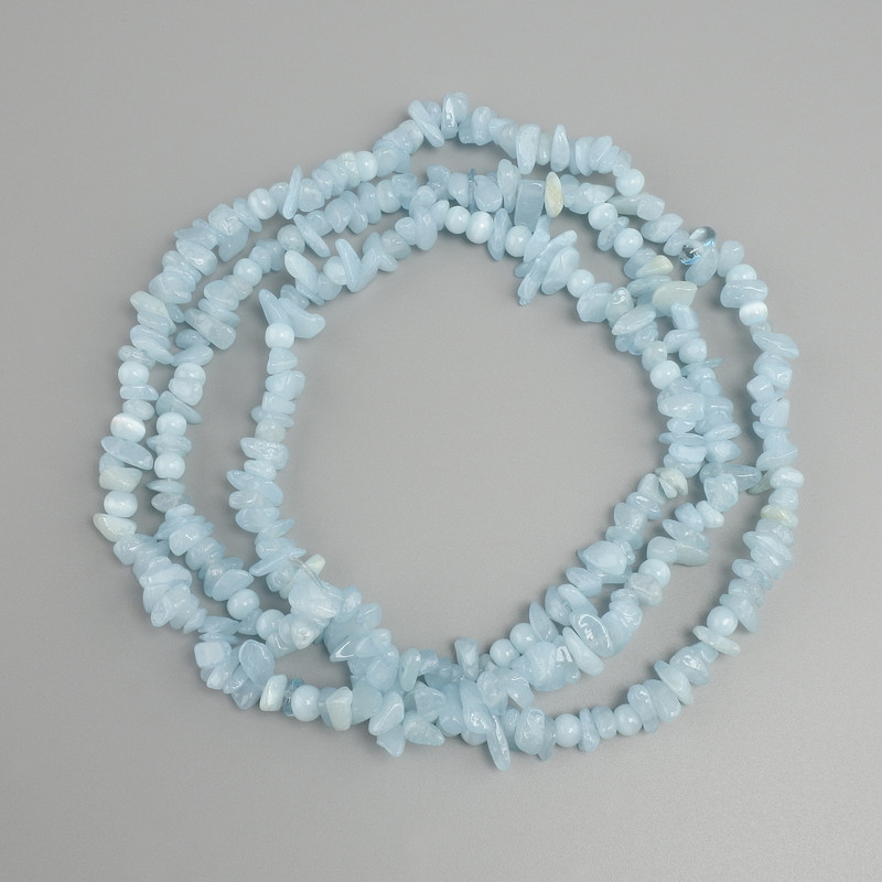 Aquamarine tumbled chips beads, diameter 4-9x2-4mm +/-, length 76cm +/-, on a nylon thread