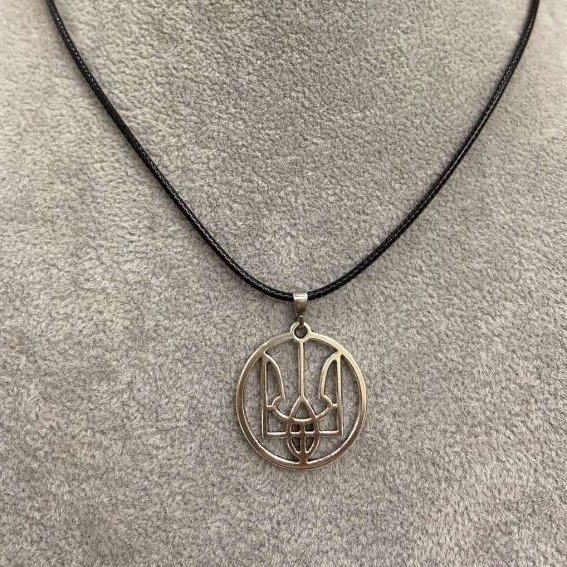 Pendant Trident in a circle, diameter 25 mm ± silver-toned metal on an eco-leather cord, length 60 cm +5 cm chain