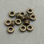 Bead insert hardware bronze color, diameter 7x4 mm ± opening diameter, hole 3.6 mm ± ~50 pcs