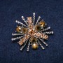 Brooch 'Order of Beauty' 45x40mm with yellow rhinestones, silver-tone metal