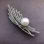 Brooch-pendant in silver-tone metal with crystals and a centerpiece bead, diameter 13mm ± 76×23mm ±