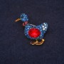 Brooch in the shape of a duck with blue rhinestones and red crystal 24x30mm