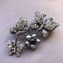 Bright Brooch with drip silver-plated metal, butterflies perched on a flower garland, dark and light rhinestones 55x34mm +
