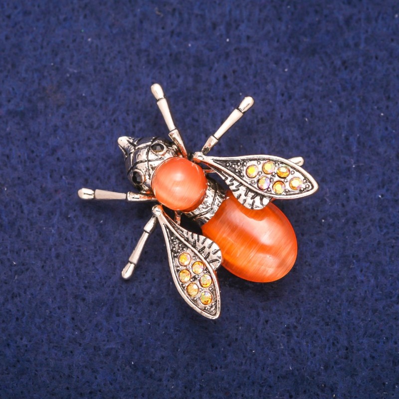 Brooch Butterfly with orange Cat's Eye and rhinestones 33x34mm, metal with golden sheen