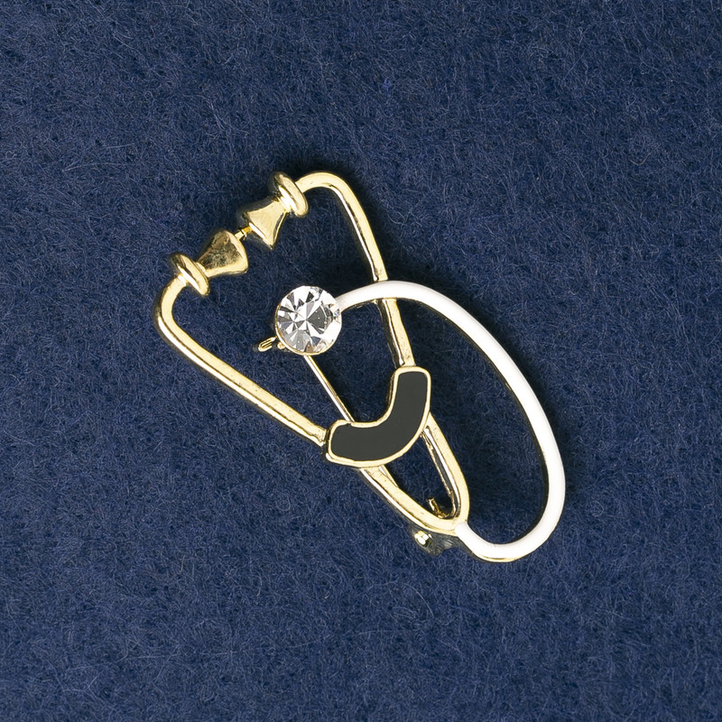 Brooch 'Stethoscope' enamel white and black with white stone, gold-tone metal 43x24mm