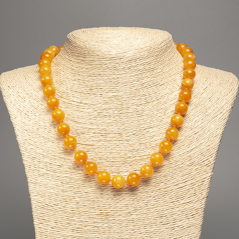 Necklace with orange amber color, smooth beads, diameter 10mm±, length 50cm± made of white jade (synthetic dyed)