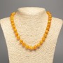 Necklace with orange amber color, smooth beads, diameter 10mm±, length 50cm± made of white jade (synthetic dyed)