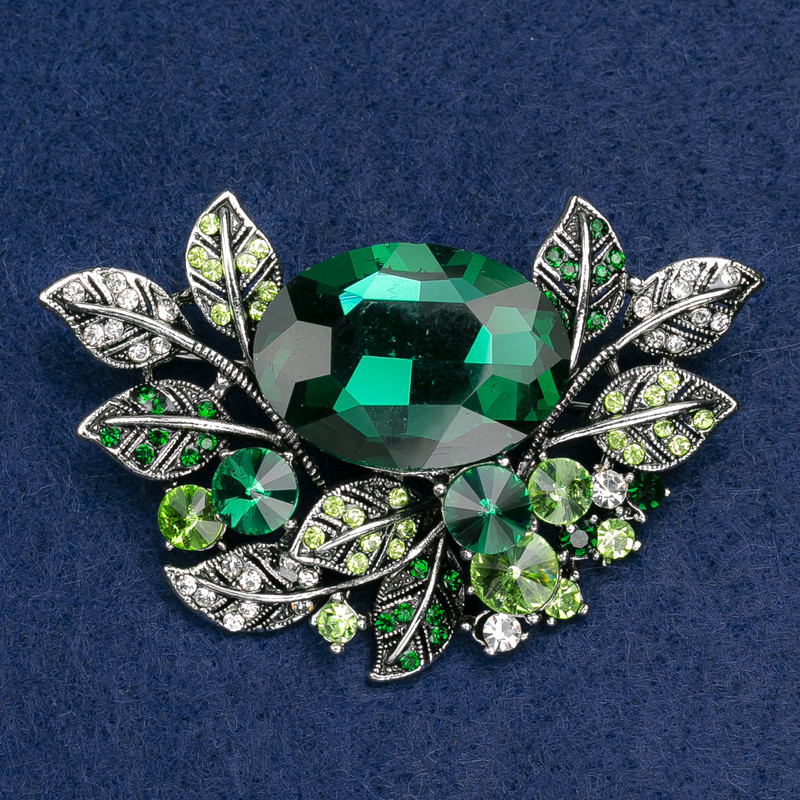 Brooch large Accent in floral design with crystals and green and white stones, silver metal, 67x46mm