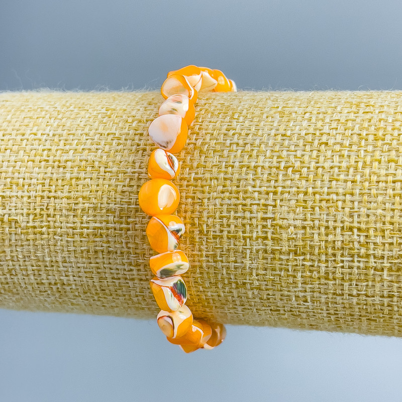Bracelet Mother of Pearl light orange faceted beads, diameter 8x6mm+-, length 18cm (stretch)