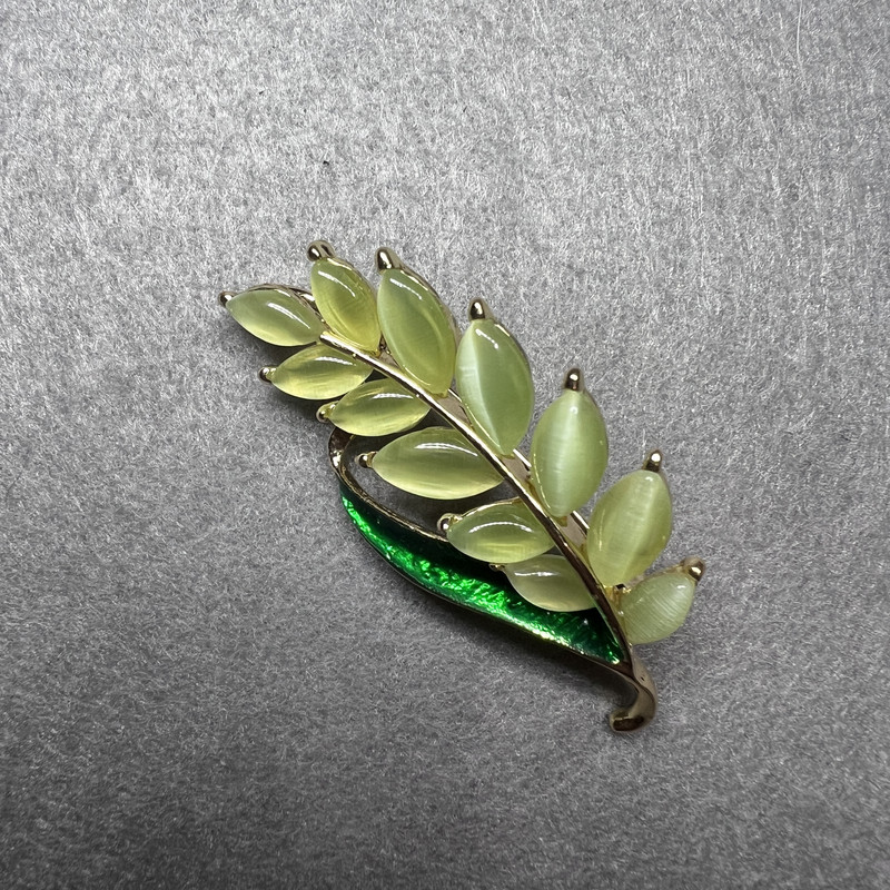Brooch Branch with green cat's eye and green enamel on golden metal 22x47mm