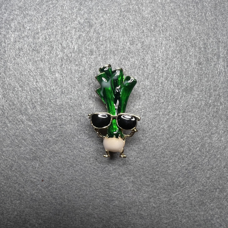 Brooch Celery in glasses green, black and white enamel, golden metal 18x32mm