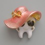 Brooch 'Tooth in a Hat' with enamel, white, pink, and black, golden metal 33x30mm