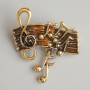 Brooch 'Notes' brown enamel, golden metal 33x26mm