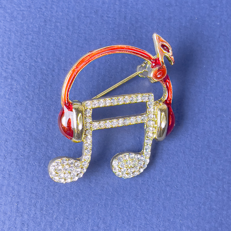 Brooch 'Note in the Headphones' with red enamel white crystals gold metal 27×32mm+